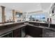 Basement wet bar with dark cabinetry and granite countertop at 132 Rollingwood Ln, Mooresville, NC 28117