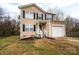 Two-story house with beige siding, black shutters, and a driveway at 1529 Brookgreen Ave, Statesville, NC 28677