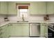 Renovated kitchen featuring light green cabinets and white quartz countertops at 160 Northcrest Dr, Kannapolis, NC 28081