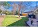 Spacious backyard with grassy lawn, mature trees, and a detached garage at 2861 Sharon Rd, Charlotte, NC 28211
