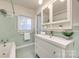Bathroom with mint green tile and a white vanity at 2861 Sharon Rd, Charlotte, NC 28211