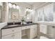 Clean bathroom with double vanity, white cabinets, and black countertops at 2861 Sharon Rd, Charlotte, NC 28211