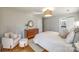Bright bedroom with hardwood floors, a dresser, and a comfortable sitting area at 2861 Sharon Rd, Charlotte, NC 28211