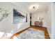 Light-filled hallway with hardwood floors and art at 2861 Sharon Rd, Charlotte, NC 28211