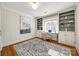 Bright home office featuring built-in shelving and hardwood floors at 2861 Sharon Rd, Charlotte, NC 28211