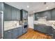 Modern kitchen with gray cabinets, stainless steel appliances, and quartz countertops at 2861 Sharon Rd, Charlotte, NC 28211