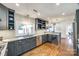Modern kitchen with gray cabinets, quartz countertops, and stainless steel appliances at 2861 Sharon Rd, Charlotte, NC 28211