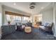 Cozy sunroom with hardwood floors, wicker chairs, and built-in bench seating at 2861 Sharon Rd, Charlotte, NC 28211