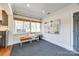 Bright sunroom with built-in bench, hardwood floors, and large windows at 2861 Sharon Rd, Charlotte, NC 28211