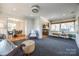 Relaxing sunroom with hardwood floors, wicker chairs, and view into dining room at 2861 Sharon Rd, Charlotte, NC 28211