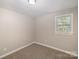 Bright bedroom with a window, carpet and neutral decor at 433 Greenwood Dr, Charlotte, NC 28217