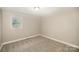 Simple bedroom with neutral walls and carpet at 433 Greenwood Dr, Charlotte, NC 28217
