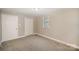 Well-lit bedroom featuring carpet and neutral decor at 433 Greenwood Dr, Charlotte, NC 28217