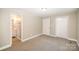 Bedroom with carpet, private bathroom access, and double closets at 433 Greenwood Dr, Charlotte, NC 28217