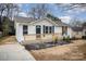 Newly renovated house featuring a white exterior,navy blue shutters, and a small front porch at 433 Greenwood Dr, Charlotte, NC 28217