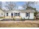 Newly renovated house featuring a white exterior,navy blue shutters, and a small front porch at 433 Greenwood Dr, Charlotte, NC 28217