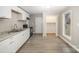 Renovated kitchen with white cabinets, granite countertops, and black appliances at 433 Greenwood Dr, Charlotte, NC 28217