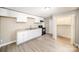 Renovated kitchen with white cabinets, granite countertops, and black appliances at 433 Greenwood Dr, Charlotte, NC 28217