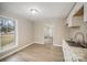 Renovated kitchen with white cabinets, granite countertops, and black appliances at 433 Greenwood Dr, Charlotte, NC 28217