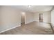 Bright living room with light gray walls, wood-look floors, and access to other rooms at 433 Greenwood Dr, Charlotte, NC 28217