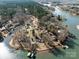 Expansive aerial view of a lakeside community with a winding shoreline, lush trees, and beautiful homes with private docks at 4465 Red Hill Cir, Denver, NC 28037