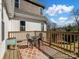 Outdoor deck featuring a table and chairs with a view of the backyard on a sunny day at 4465 Red Hill Cir, Denver, NC 28037