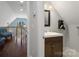 Hallway bathroom with modern fixtures, hardwood floors and ample lighting at 4465 Red Hill Cir, Denver, NC 28037