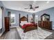 Spacious main bedroom with a king bed, dark wood furniture, and natural light at 4465 Red Hill Cir, Denver, NC 28037