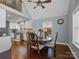 Sunlit dining area features hardwood floors, a round wood table, and kitchen access at 4465 Red Hill Cir, Denver, NC 28037