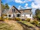 Charming home with a mix of white siding and brown shingles, complemented by lush green landscaping at 4465 Red Hill Cir, Denver, NC 28037