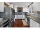 Modern kitchen featuring stainless steel appliances, white cabinets, gray countertops and tile backsplash at 4465 Red Hill Cir, Denver, NC 28037