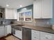 Modern kitchen featuring stainless steel appliances, white cabinets, gray countertops and tile backsplash at 4465 Red Hill Cir, Denver, NC 28037