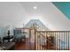 Bright and airy loft area with hardwood floors, a cozy sitting area, and natural light at 4465 Red Hill Cir, Denver, NC 28037