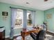 Office with mint walls, a wood desk, large windows, and view of the outdoors at 4465 Red Hill Cir, Denver, NC 28037
