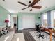 View of the office with mint walls, wood floors, closet, couch, and large windows at 4465 Red Hill Cir, Denver, NC 28037