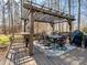 Outdoor dining area with pergola, table, chairs, and grill on a wooden deck at 4465 Red Hill Cir, Denver, NC 28037