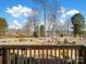 Scenic view from the porch showing the lake and surrounding landscape under a blue sky at 4465 Red Hill Cir, Denver, NC 28037