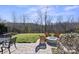 Landscaped backyard with fire pit and patio area at 5002 Looking Glass Trl, Denver, NC 28037
