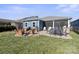 Spacious backyard with patio, fire pit and view of wooded area at 5002 Looking Glass Trl, Denver, NC 28037