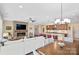 Open floor plan boasts a spacious living area, kitchen island, and fireplace at 5002 Looking Glass Trl, Denver, NC 28037