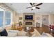 Bright living room features a stone fireplace and hardwood floors at 5002 Looking Glass Trl, Denver, NC 28037