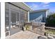 Built-in outdoor kitchen with grill and screened porch access at 5002 Looking Glass Trl, Denver, NC 28037