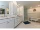 This bathroom offers double sinks, a glass enclosed shower, and a luxurious soaking tub at 525 Pine Rd, Davidson, NC 28036