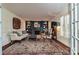 Elegant living room with fireplace, custom bookshelves, plantation shutters, and hardwood floors at 525 Pine Rd, Davidson, NC 28036