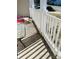 Inviting front porch with modern white railing and an adorable fluffy dog greeting visitors at 640 Mckee St, Albemarle, NC 28001