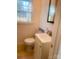 Neat powder room, bright white fixtures and a window letting in lots of natural light at 640 Mckee St, Albemarle, NC 28001