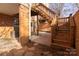 Brick patio and wooden deck with stairs, offering outdoor space at 6742 Constitution Ln, Charlotte, NC 28210