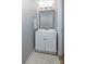 Simple bathroom with single vanity and a small mirror at 6742 Constitution Ln, Charlotte, NC 28210