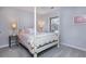 Charming bedroom with a four-poster bed and soft color palette at 6742 Constitution Ln, Charlotte, NC 28210