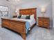 Spacious bedroom with a wooden bed frame and ample closet space at 6742 Constitution Ln, Charlotte, NC 28210
